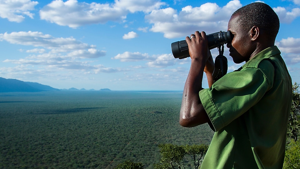 Man watching through binocular